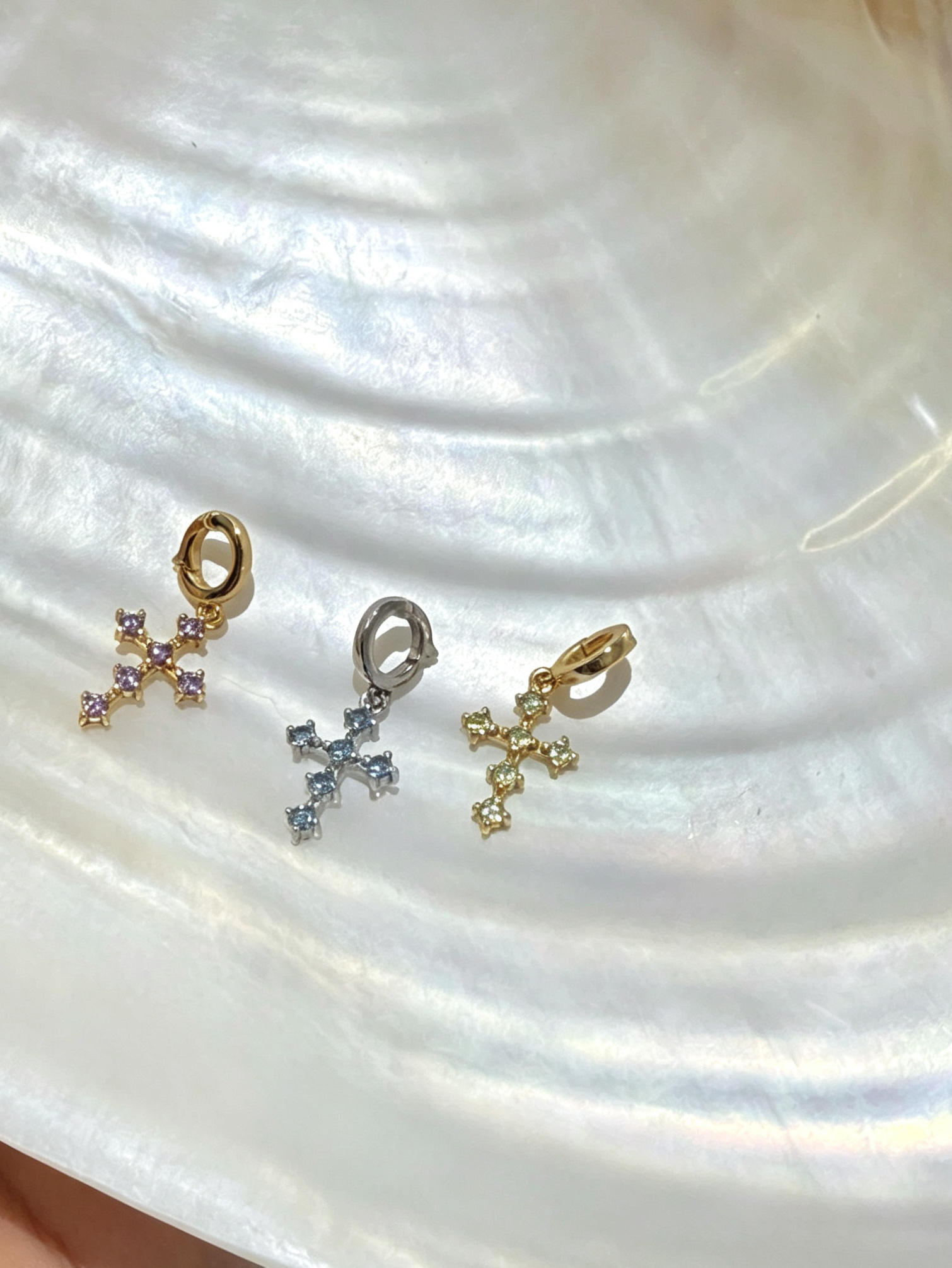 Juna Rae clip-on cross charms styled on a crystal bead necklace